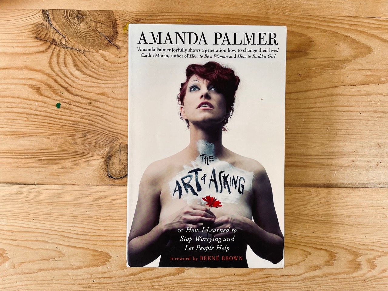 The Art of Asking by Amanda Palmer on a table with front cover on display